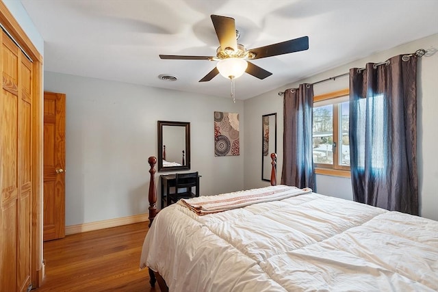 bedroom with a closet, ceiling fan, and light wood-type flooring