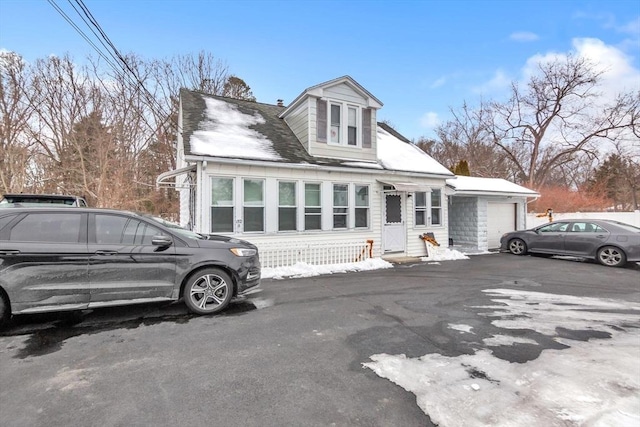 view of front of house with entry steps, aphalt driveway, and an attached garage