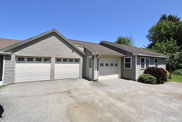 25 Rollinson Rd, Worcester, MA 01606 - ranch-style house featuring a garage, driveway, and a shingled roof