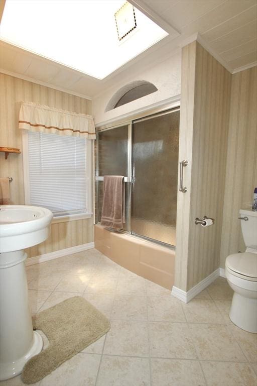 25 Rollinson Rd, Worcester, MA 01606 - bathroom featuring toilet, tile patterned flooring, combined bath / shower with glass door, wood walls, and baseboards