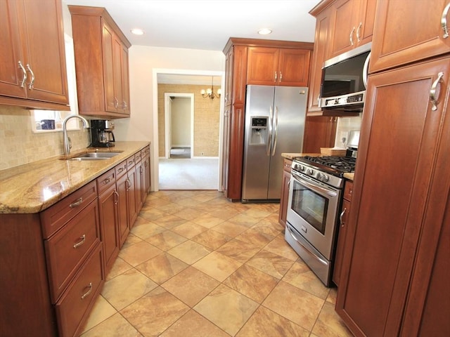25 Rollinson Rd, Worcester, MA 01606 - kitchen with appliances with stainless steel finishes, a sink, light stone counters, tasteful backsplash, and a chandelier
