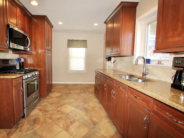 25 Rollinson Rd, Worcester, MA 01606 - kitchen featuring stainless steel appliances, a sink, backsplash, light stone countertops, and baseboards