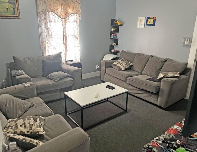 carpeted living area with baseboards