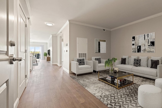 living room with crown molding and light wood-type flooring