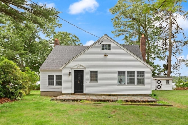 39 Faye Ave, Middleboro, MA 02346 - back of property featuring a chimney, a lawn, an outbuilding, and a shingled roof