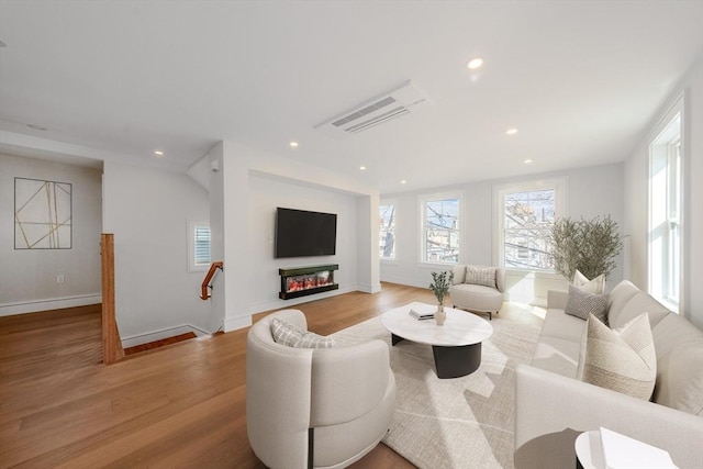 living room featuring baseboards, wood finished floors, visible vents, and recessed lighting