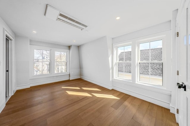 spare room with recessed lighting, wood finished floors, and baseboards