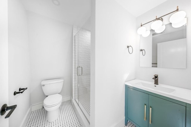 bathroom with toilet, a shower stall, baseboards, and vanity