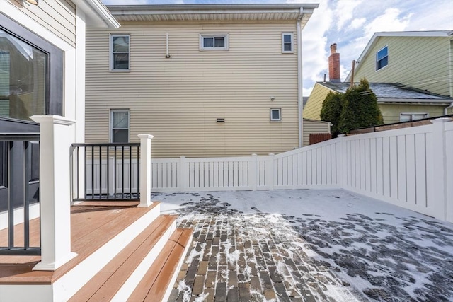 back of house featuring fence and a wooden deck