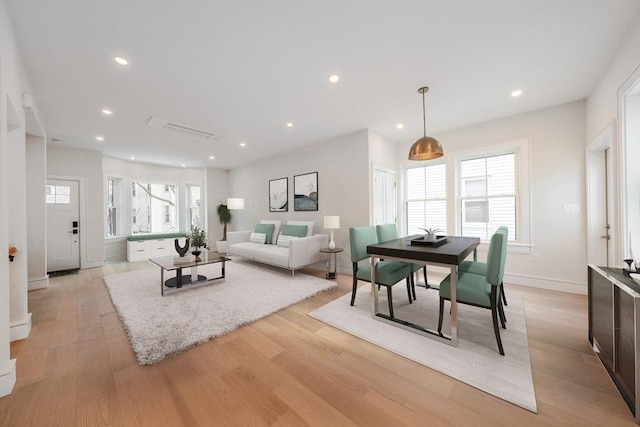 living room with baseboards, light wood-style flooring, and recessed lighting