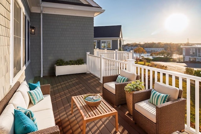 balcony at dusk featuring an outdoor living space