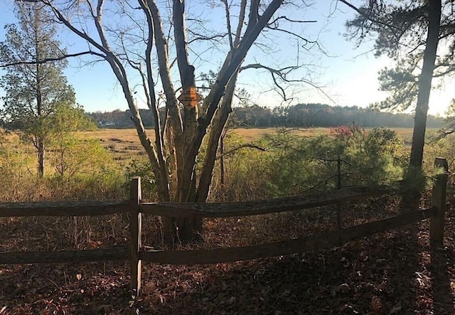 view of yard with a rural view and fence