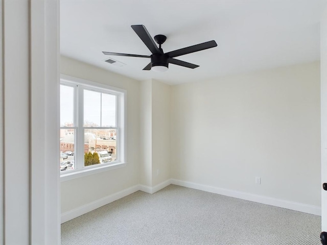 empty room featuring light carpet, ceiling fan, and a healthy amount of sunlight