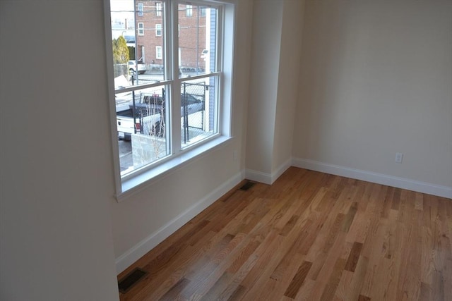 unfurnished room with light wood-type flooring