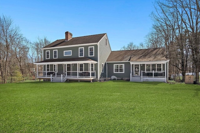 back of property featuring a yard, covered porch, a chimney, and a sunroom