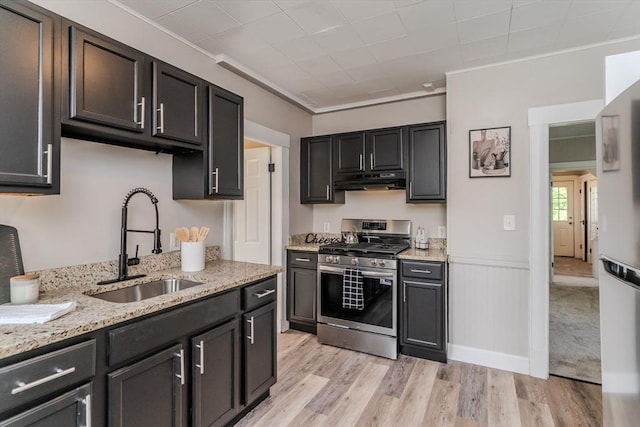 33-35 Claremont St, Springfield, MA 01108 - kitchen with stainless steel gas range, a sink, light wood finished floors, light stone counters, and under cabinet range hood