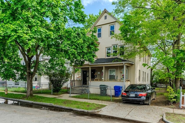 33-35 Claremont St, Springfield, MA 01108 - view of front facade with a porch and a fenced front yard