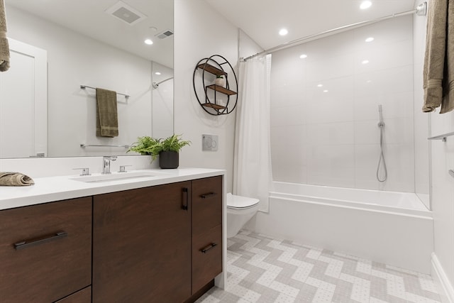 full bathroom with shower / bath combination with curtain, vanity, and toilet