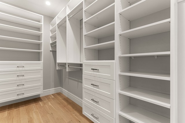 spacious closet with light hardwood / wood-style flooring