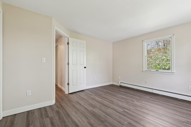 89 Brush Hill Rd, Sherborn, MA 01770 - empty room featuring wood finished floors, baseboards, and a baseboard heating unit