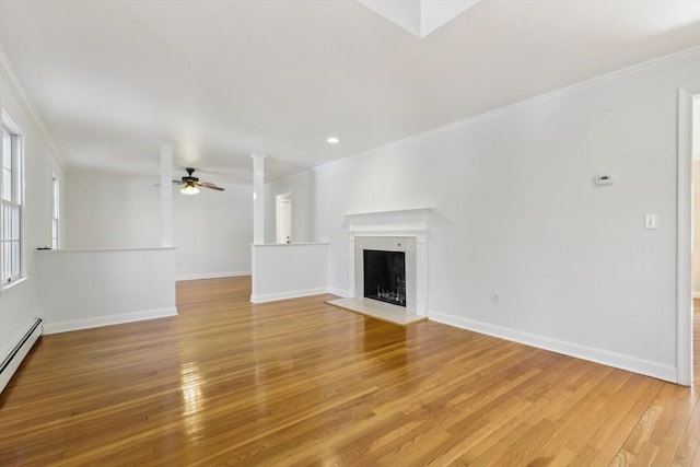 89 Brush Hill Rd, Sherborn, MA 01770 - unfurnished living room with ornamental molding, a fireplace, light wood-type flooring, and ceiling fan