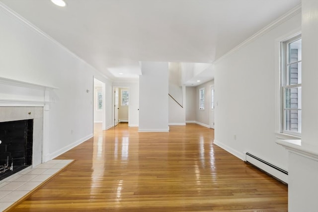 89 Brush Hill Rd, Sherborn, MA 01770 - unfurnished living room featuring a tiled fireplace, a baseboard radiator, light wood-style flooring, and a healthy amount of sunlight