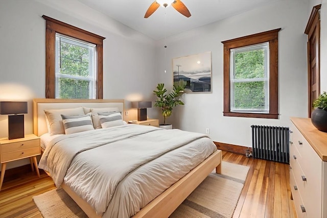 50 Switzer Ave, Springfield, MA 01109 - bedroom with radiator, light wood-style floors, and ceiling fan