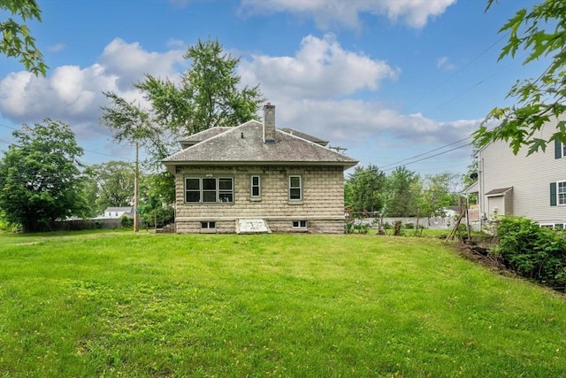 50 Switzer Ave, Springfield, MA 01109 - rear view of house with a chimney, a lawn, and roof with shingles