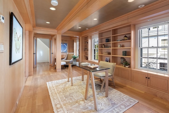 office area featuring light wood-type flooring, built in features, and ornamental molding