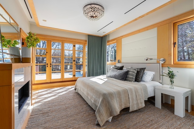 bedroom with multiple windows and wood-type flooring