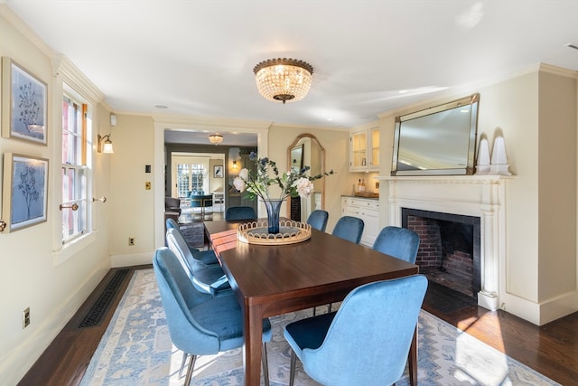 dining space featuring hardwood / wood-style floors, a chandelier, and ornamental molding