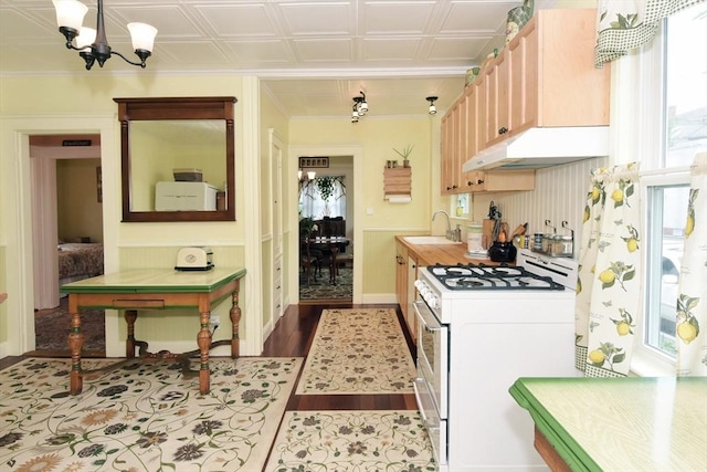 27 Ocean Ave Unit 1, Salem, MA 01970 - kitchen featuring white range with gas cooktop, under cabinet range hood, a chandelier, and light countertops