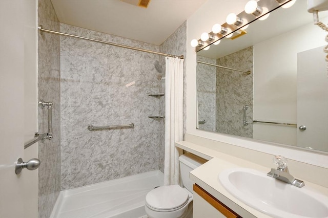 full bath with vanity, a stall shower, and toilet
