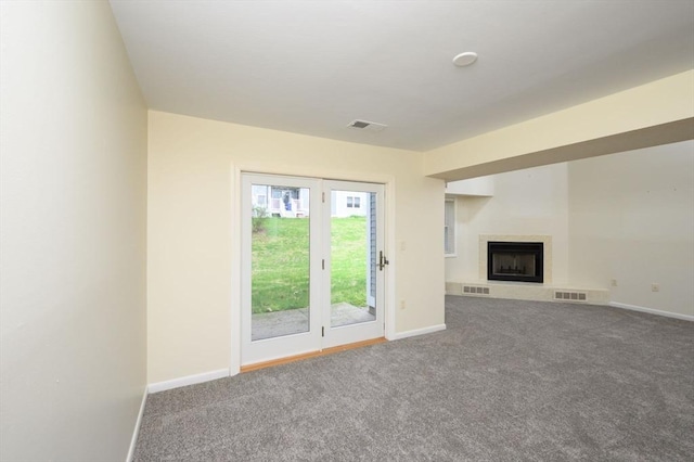 unfurnished living room with carpet and visible vents