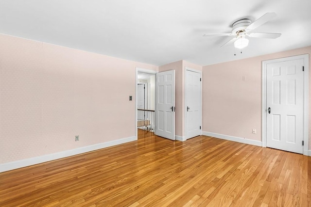 unfurnished bedroom featuring light wood-style floors and baseboards