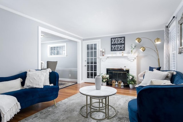 living room featuring crown molding, hardwood / wood-style flooring, and a fireplace