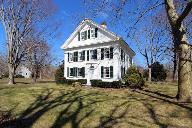 greek revival house featuring a front yard