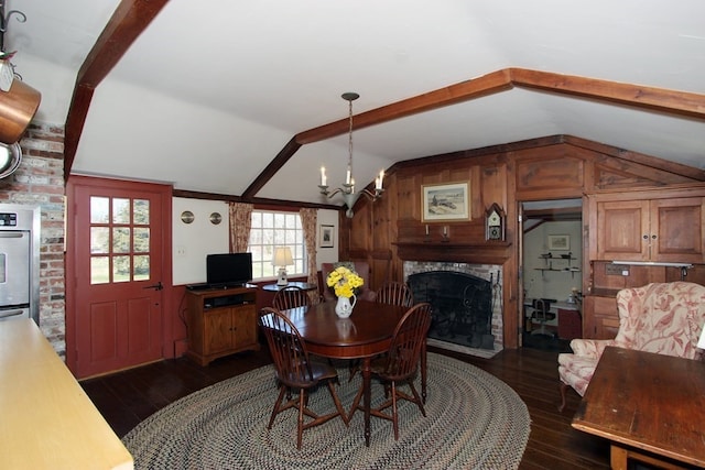 dining space with lofted ceiling with beams, brick wall, and plenty of natural light