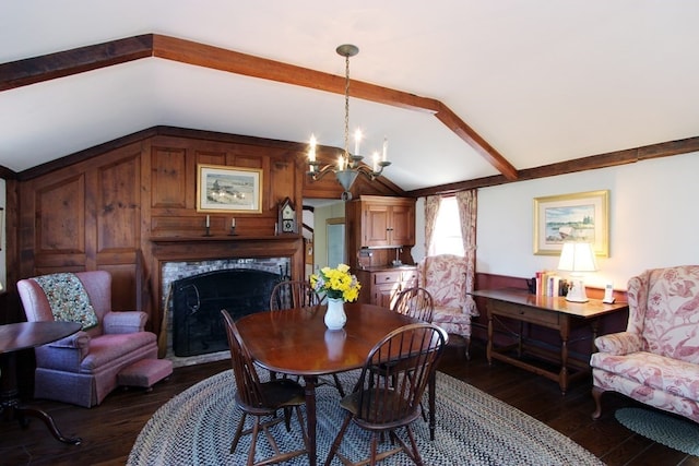 dining area with dark hardwood / wood-style floors, an inviting chandelier, and vaulted ceiling