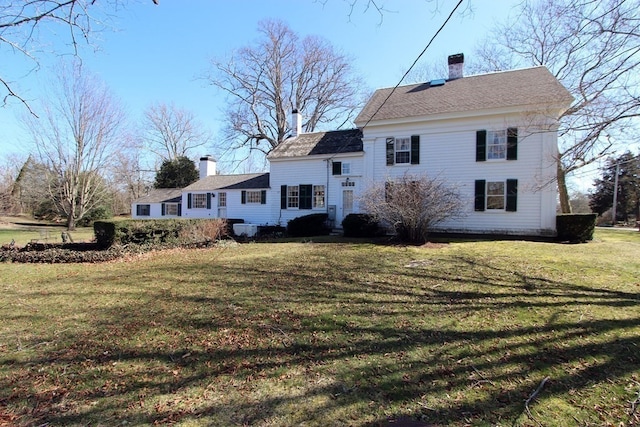 rear view of property with a yard