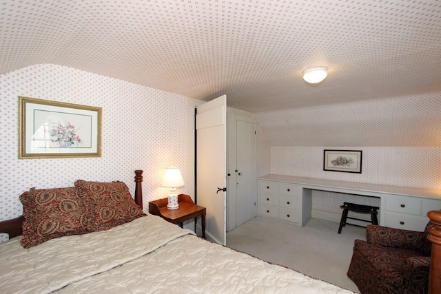 carpeted bedroom with lofted ceiling