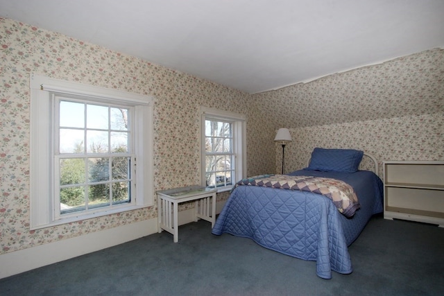 bedroom with multiple windows and dark carpet