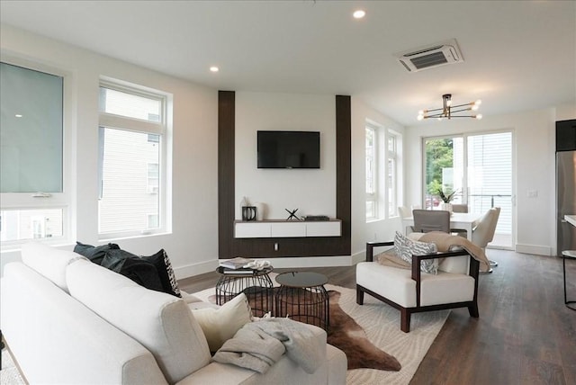 living area featuring visible vents, recessed lighting, an inviting chandelier, and wood finished floors