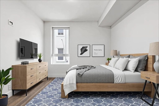 bedroom featuring baseboards and wood finished floors