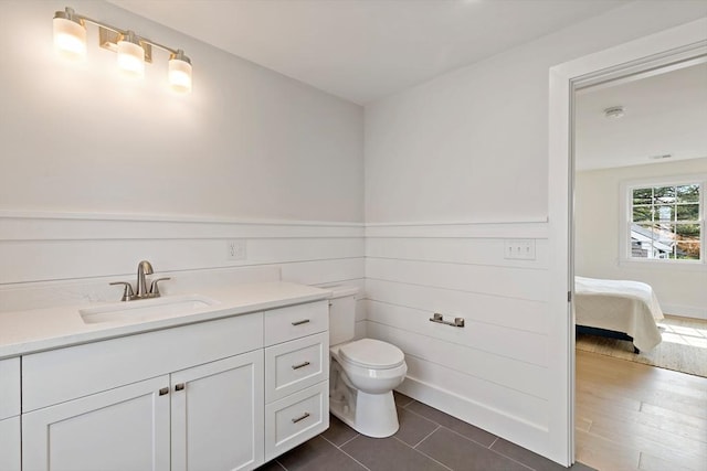 33 Dexter Ave, Sandwich, MA 02563 - bathroom featuring toilet, vanity, tile patterned floors, and ensuite bathroom