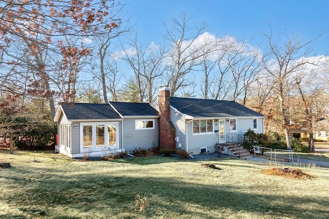 back of house with a lawn