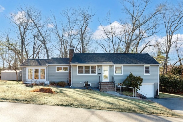 view of front facade with a front yard and a garage