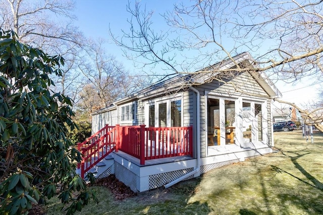 rear view of property with a lawn