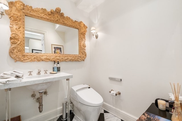 bathroom featuring tile floors and toilet