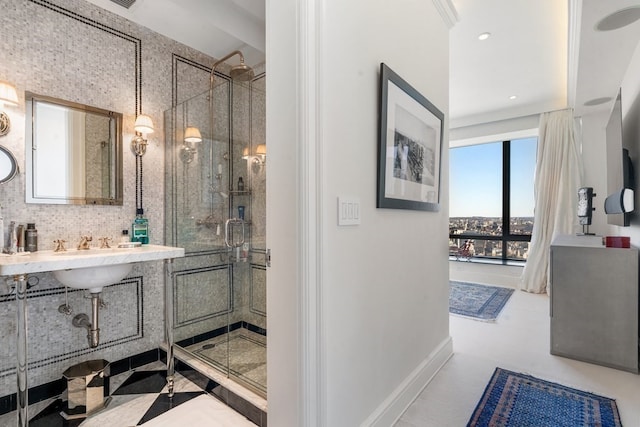 bathroom with tile flooring, a shower with door, tasteful backsplash, and vanity